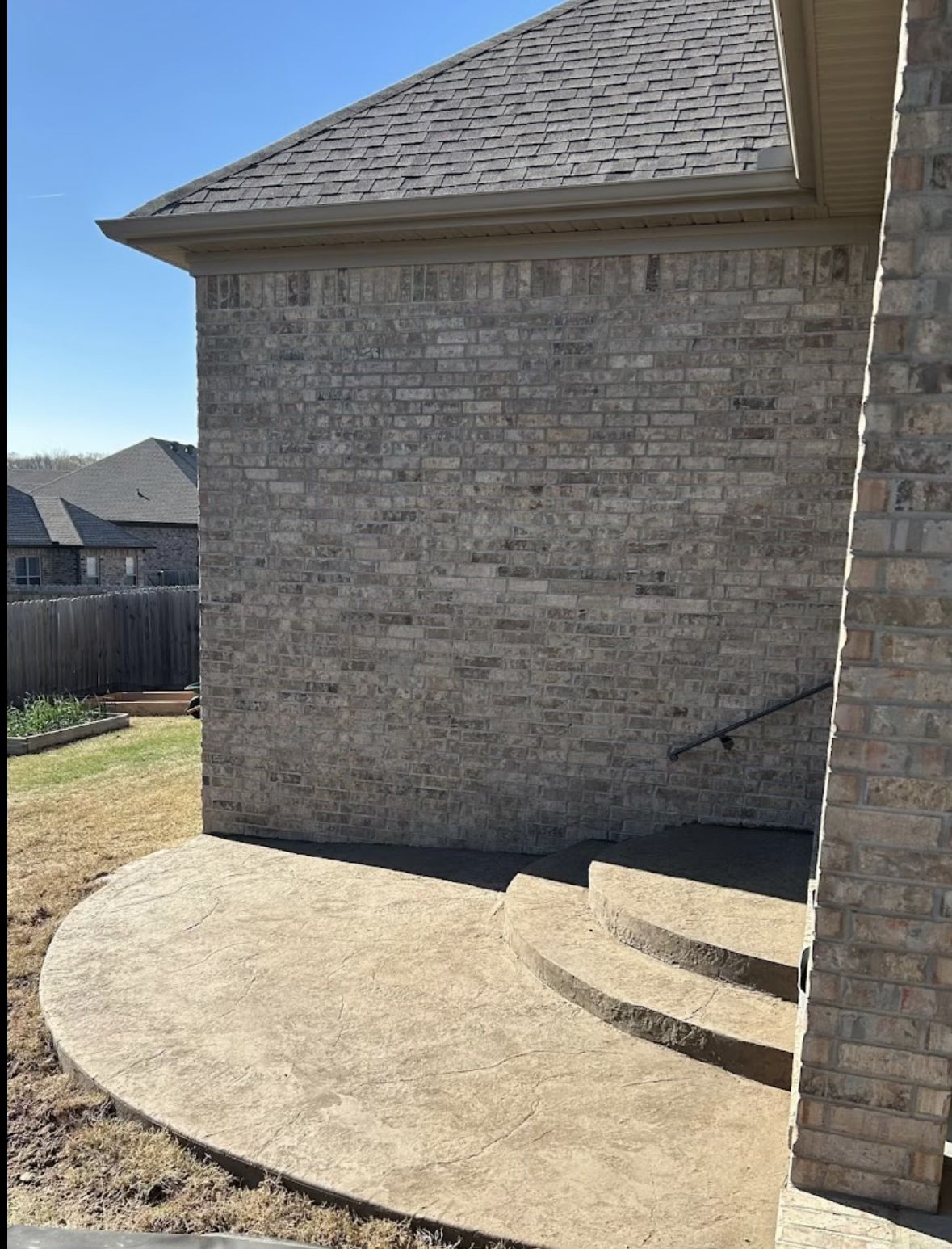 Curved stamped concrete patio with steps in Arkansas